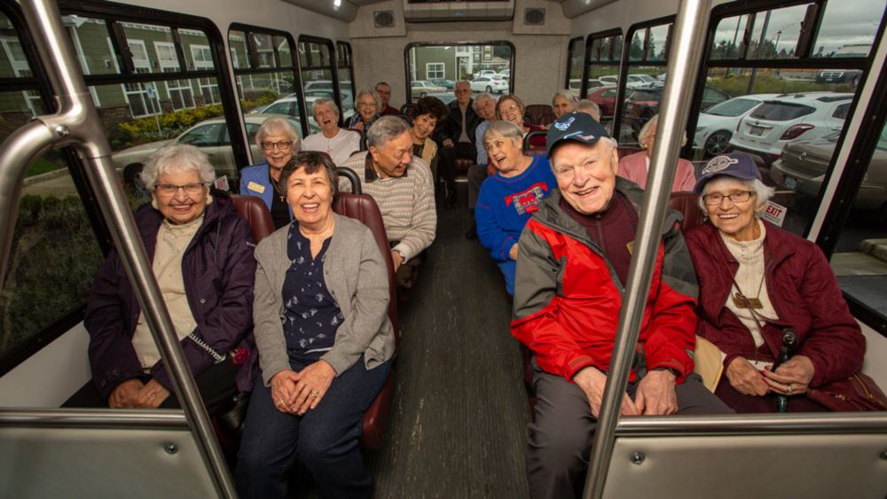 Riverwalk Estates happy seniors on a bus.